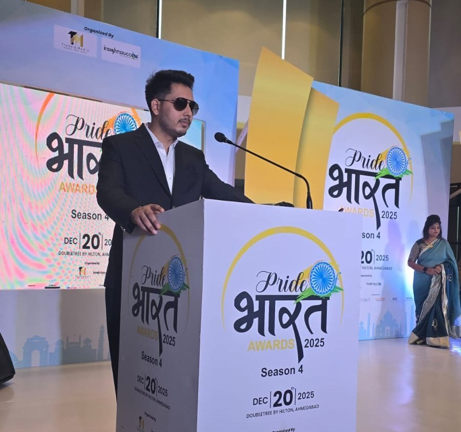 Naresh Joshi speaking on stage at the Pride Bharat awards event